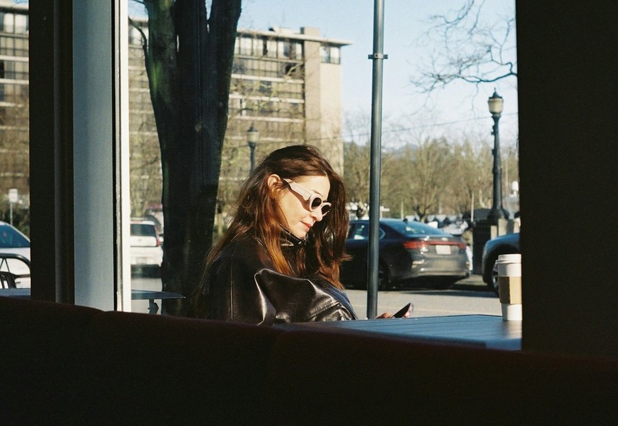 Woman at a cafe window. Photo by Farnaz Kohankhaki on Unsplash.